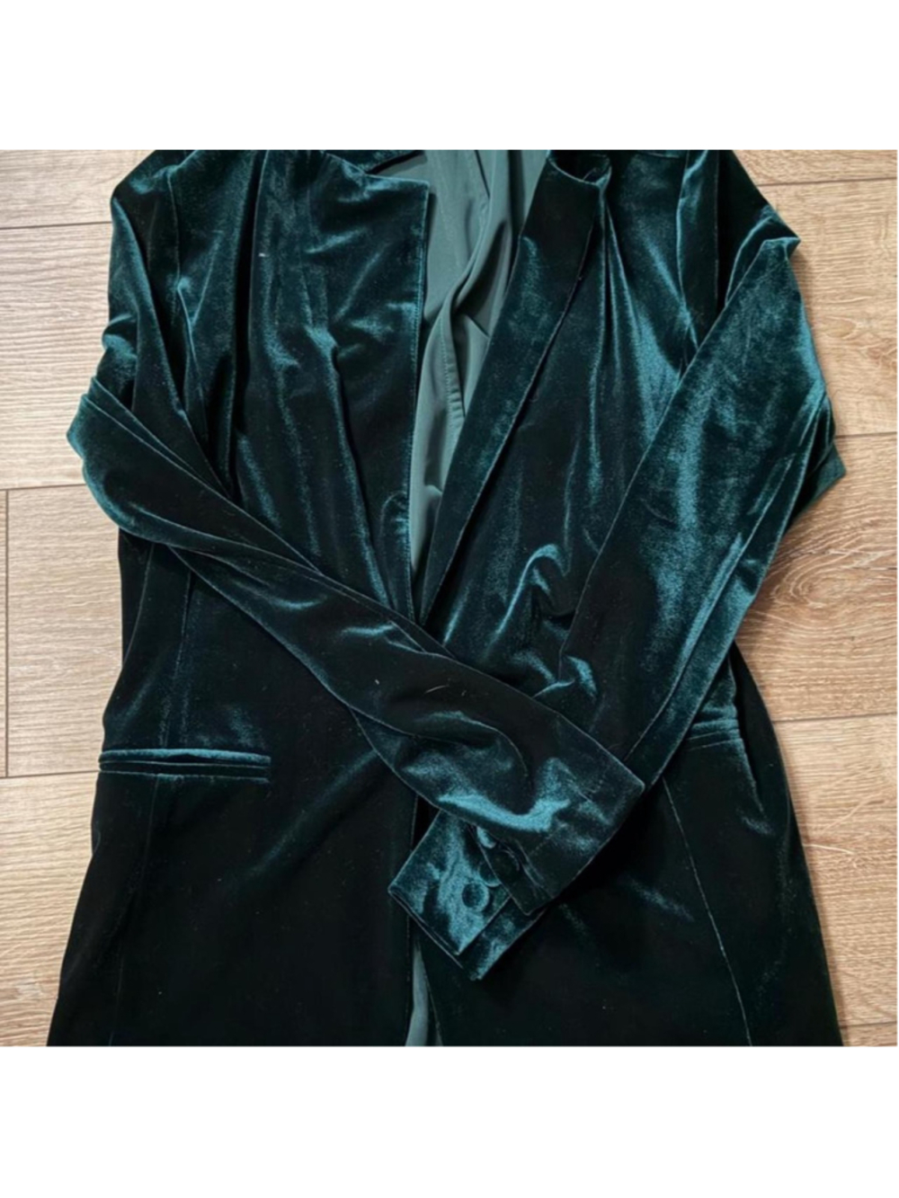 Emerald green velvet blazer with a rich jewel-tone finish